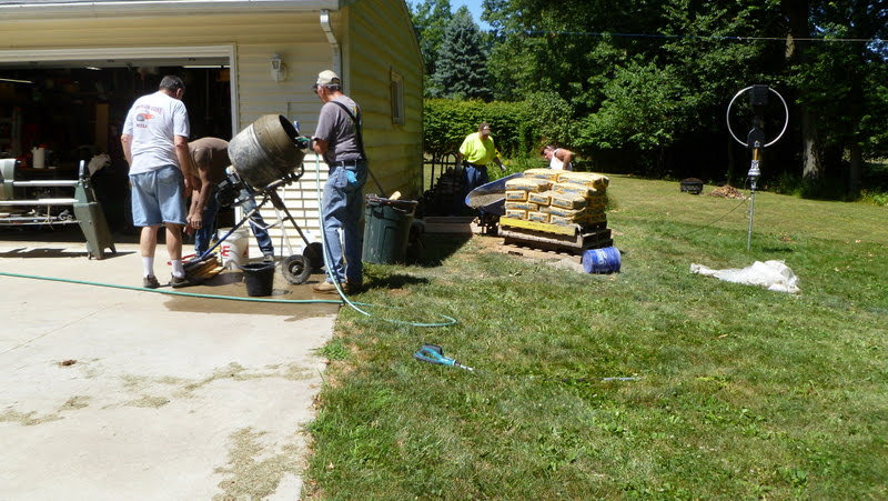 Thad Foster, KE8LVA, and N8RNK mixing concrete