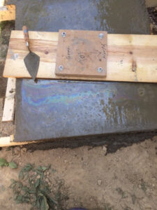 Freshly poured concrete for antenna tower footer.