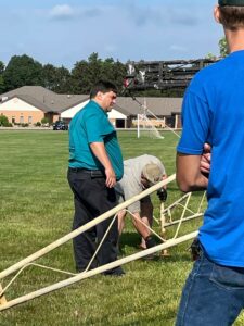 Dave N8GZ and Steve KC8MIW adjusting out riggers on portable antenna tower for 2021 ARRL field day.